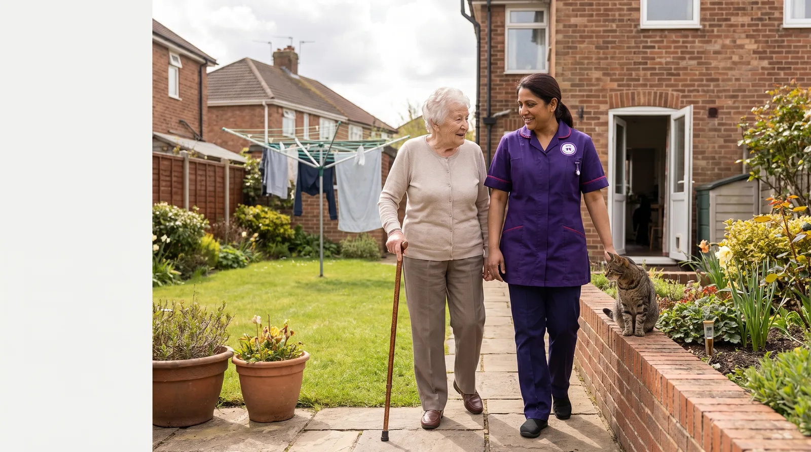Murray Healthcare live in carer walking in the garden with an older woman at her home in Leicester